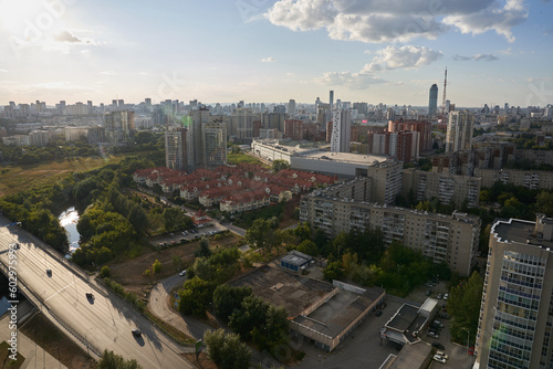 The dense construction of the city is visible from above. Small two-storey houses stand in a row. Against the background of a blue sky with clouds, a bird's-eye view of the millionaire city.