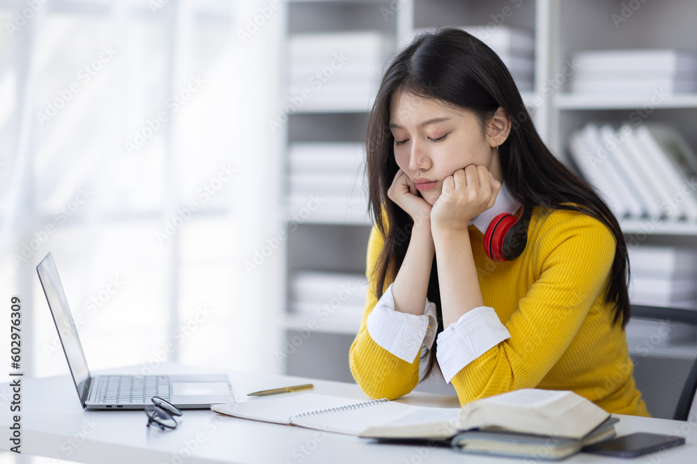Young student asian girl dressed in casual wear worried about coursework project thinking about researchers sitting, interior, female manager confused with planning working schedule making solution Young student asian girl dressed in casual wear worried about coursework project thinking about researchers sitting, interior, female manager confused with planning working schedule making solution