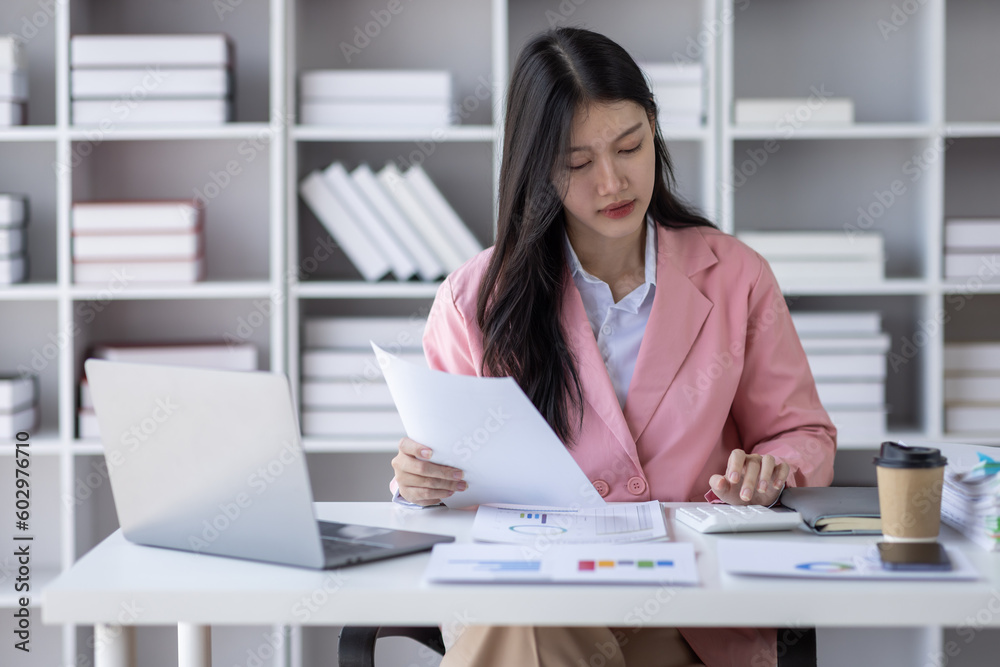 Business asian woman signs an electronic document on a digital document on a virtual laptop computer screen,Paperless workplace idea, e-signing, electronic signature, document management. Business asian woman signs an electronic document on a digital document on a virtual laptop computer screen,Paperless workplace idea, e-signing, electronic signature, document management.