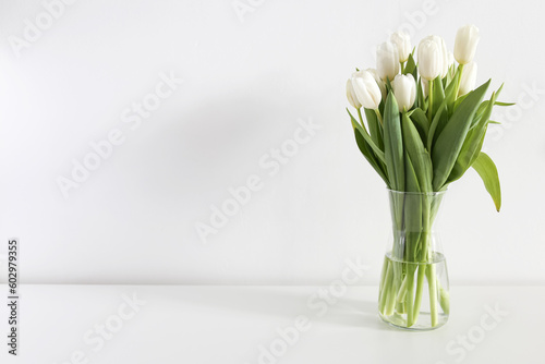 Fototapeta Naklejka Na Ścianę i Meble -  bouquet of white tulips in a vase on a white background