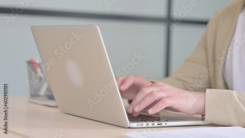 Close Up of Businessman Typing on Laptop
