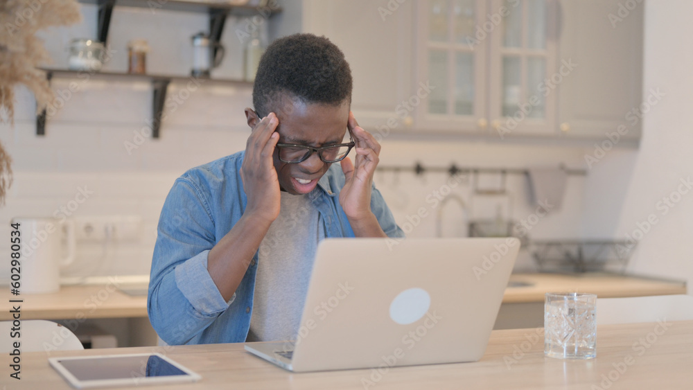 Young African Man with Headache Working on Laptop Young African Man with Headache Working on Laptop