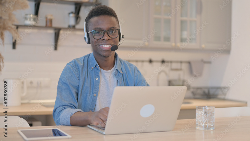 Young African Man with Headset Smiling at Camera in Call Center Young African Man with Headset Smiling at Camera in Call Center