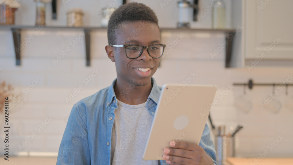 Portrait of Young African Man Doing Video Chat on Tablet Portrait of Young African Man Doing Video Chat on Tablet