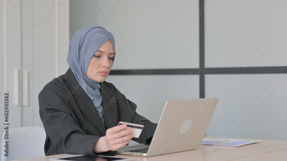 Muslim Businesswoman Doing Online Shopping on Laptop Muslim Businesswoman Doing Online Shopping on Laptop