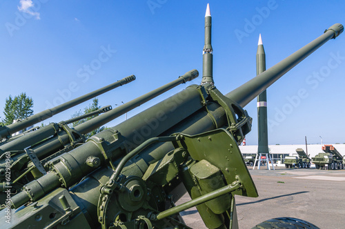 An artillery piece. Weapons of the army. The barrel of the cannon. Towed artillery piece on wheels. A large caliber cannon for dealing damage at a great distance during combat operations.