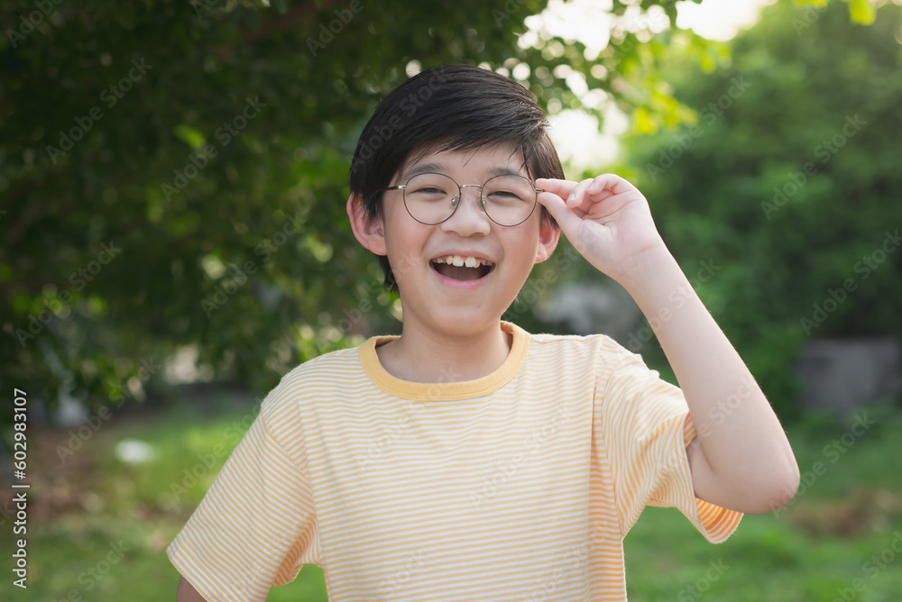 Portrait of asian child wearing glasses smiling with nature background Portrait of asian child wearing glasses smiling with nature background
