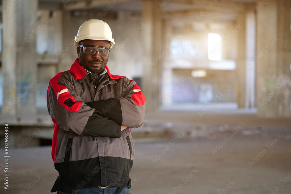 African american worker stands at construction area and looks at camera African american worker stands at construction area and looks at camera