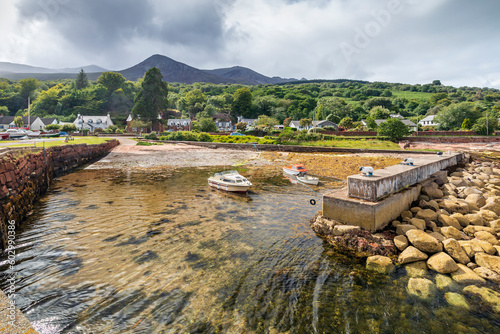 Boats moored at Sandstone Quay (also called Sheep Harbour), well known for its sheep cleats, at Corrie, Isle of Arran, Scotland. photo