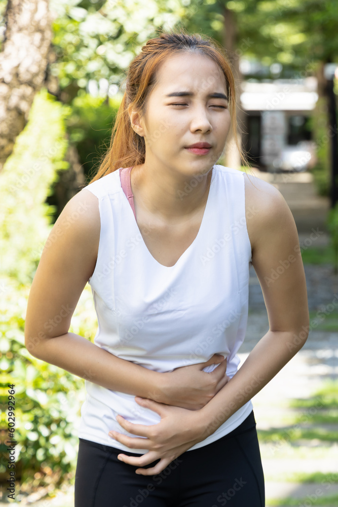 Painful sports woman, fitness woman suffering from stomachache, diarrhea, constipation, food poisoning, sports injury Painful sports woman, fitness woman suffering from stomachache, diarrhea, constipation, food poisoning, sports injury