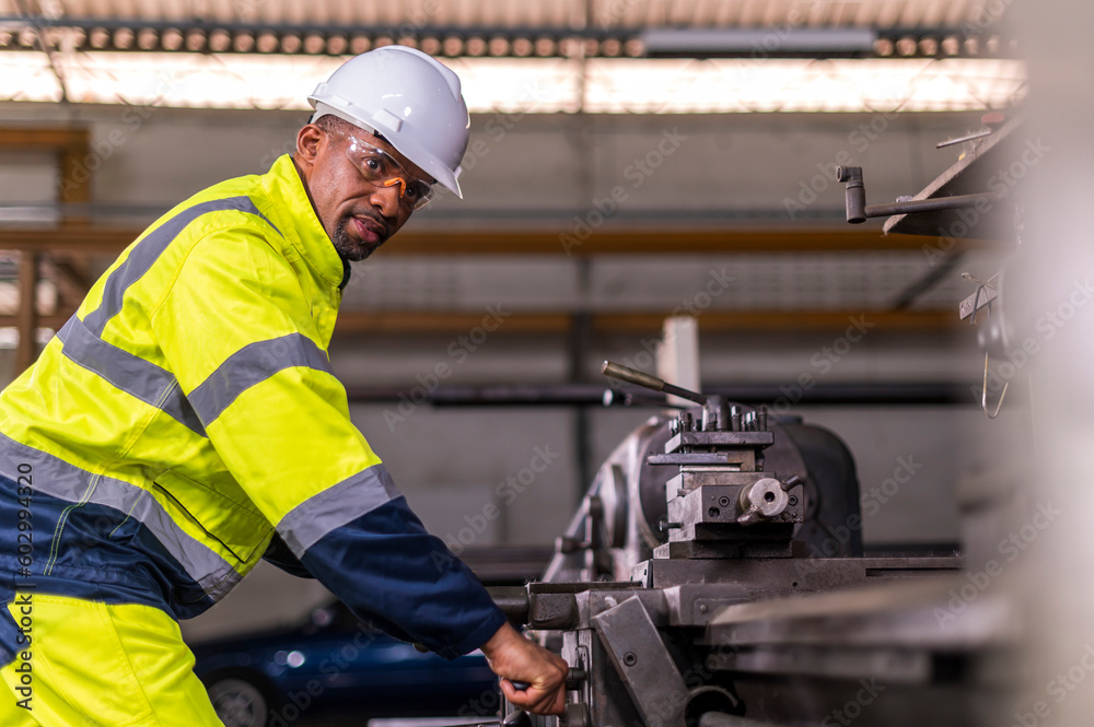 African worker Engineer working with cnc lathe machine for quality of product in factory with confident African worker Engineer working with cnc lathe machine for quality of product in factory with confident
