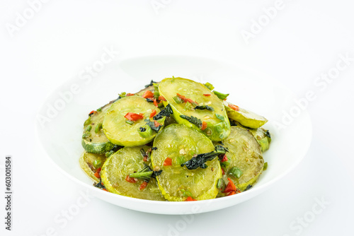 Fried cucumbers with perilla on a plate on a white background