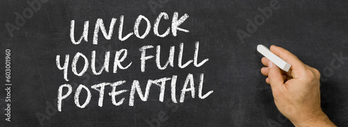  Text written on a blackboard -  Unlock your full potential