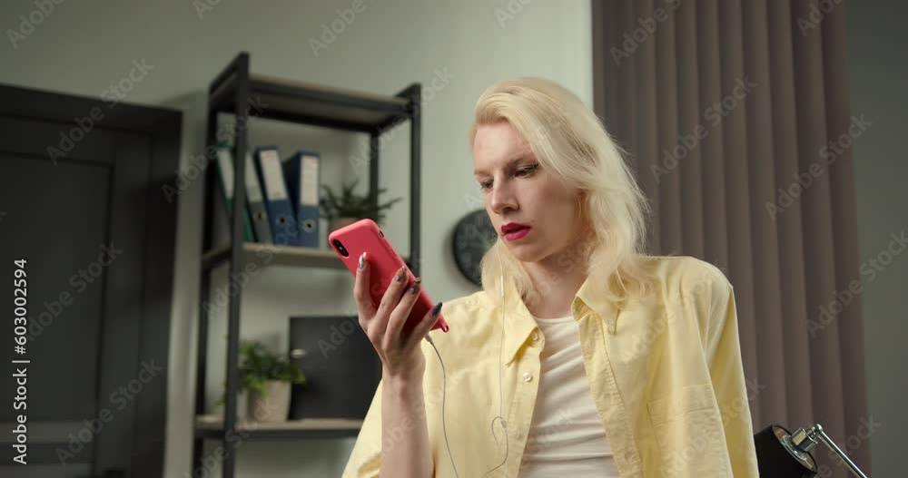 Transgender young man using a smartphone at workplace Transgender young man using a smartphone at workplace