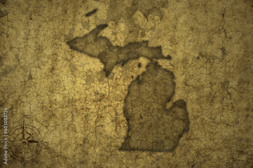 map of michigan state on a old vintage crack paper background .