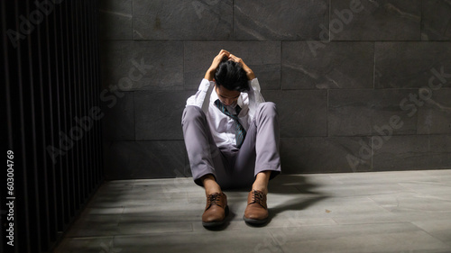 Portrait man stressed sad and tired from over working. Overworked and worried. male business man worker sitting on the floor and dark background