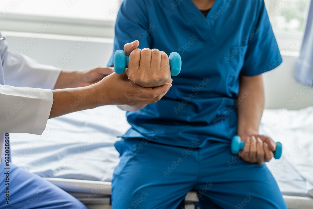 Using dumbbell, Physiotherapy specialists help patients in physiotherapy. about Muscle Weakness and Fatigue
