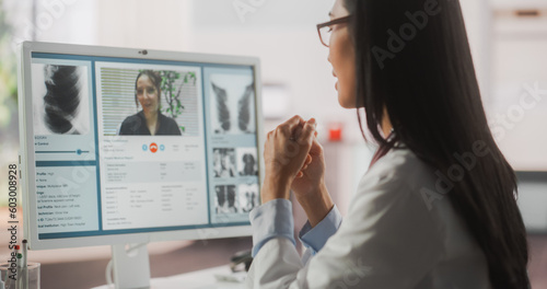 Hospital Medical Doctor Office: Portrait of Professional Female Physician Working on Desktop Computer, Talking to a Patient on a Internet Video Call Consultations, Writing Digital Prescriptions