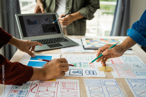 Photography Group of asian creative team programing designers participate in all phases of the UX design