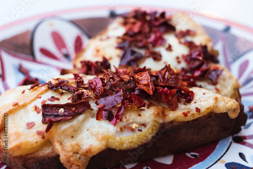 Obraz na płótnie Traditional Matera Italy antipasti appetizer - bruschetta with homemade bread, caciocavallo podolico cheese, pear and dried peppers powder w salonie