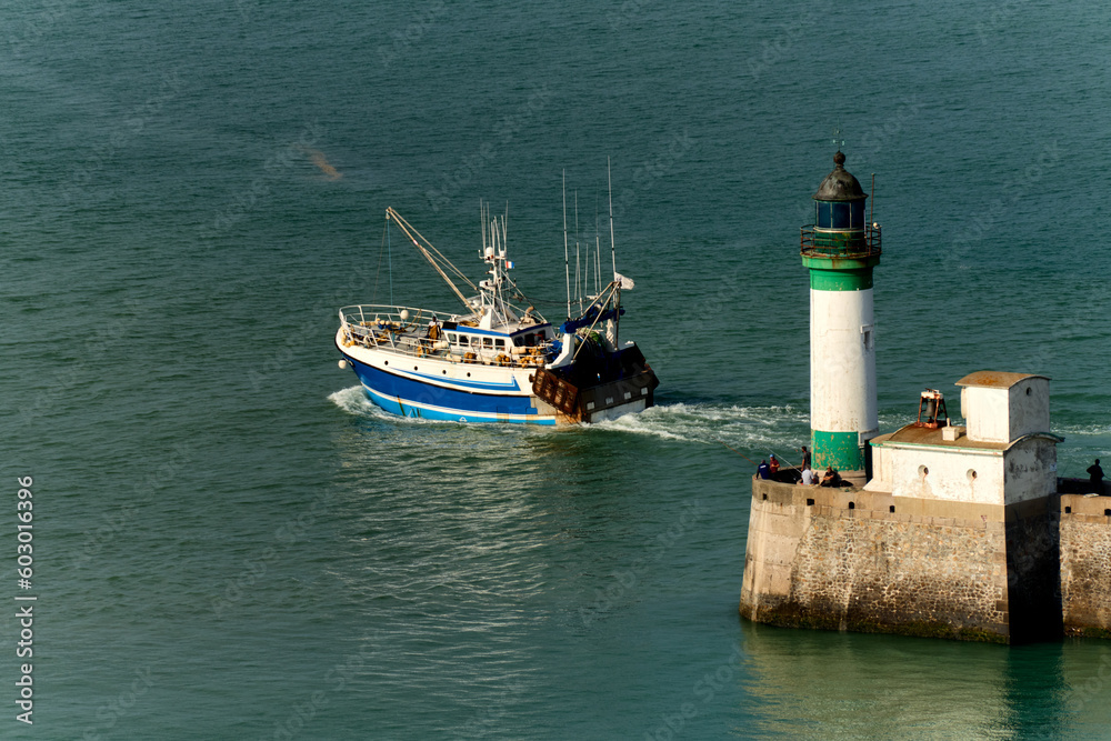 lighthouse, fishing boat and pier at Le Treport, Seine-Maritime department in Normandy, France.