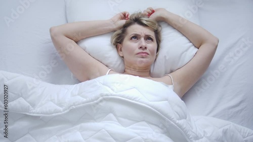 Lazy restless woman waking up early in morning in her day off because of loud neighbours, poor soundproofing and good audibility of house