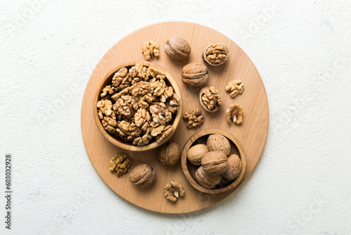 Fresh healthy walnuts in bowl on colored table background. Top view Healthy eating bertholletia concept. Super foods