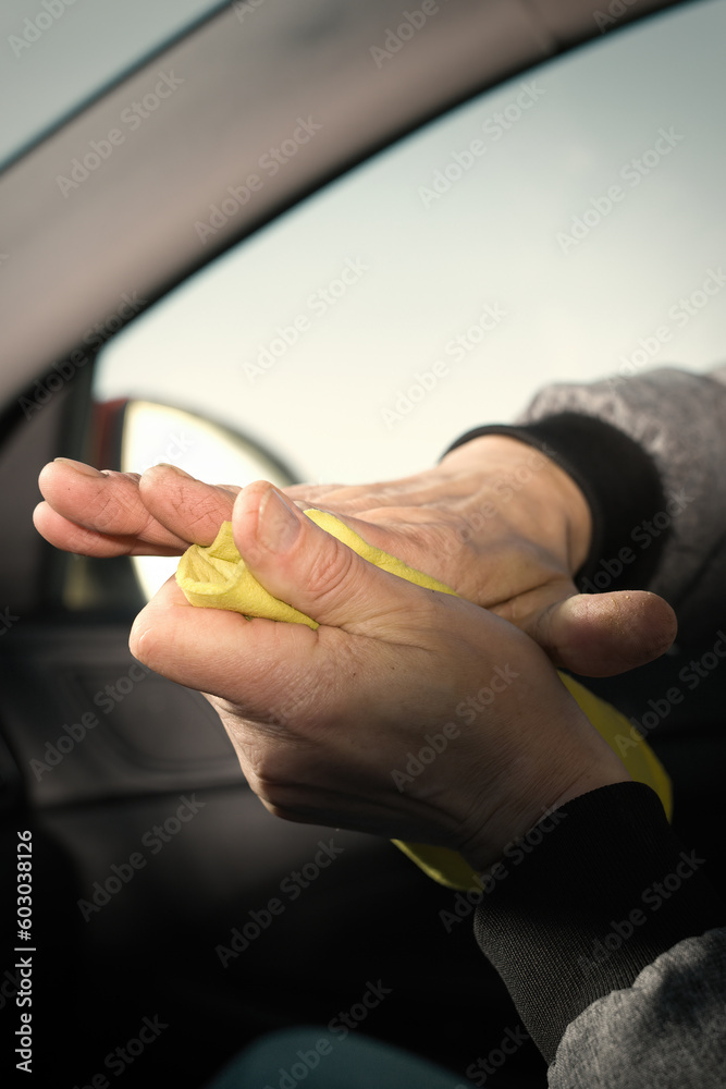 Older man take care annd cleaning car interior on nature parking