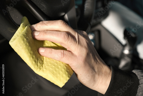 Older man take care annd cleaning car interior on nature parking