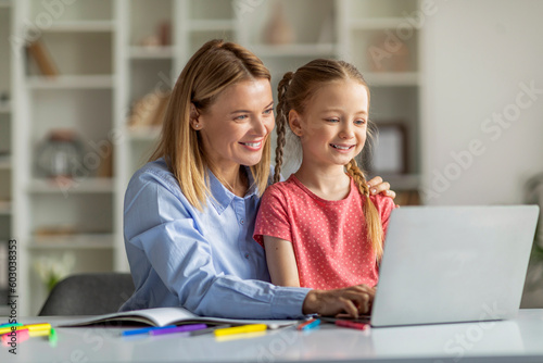 Wallpaper Mural Online Education. Smiling Mother And Her Little Daughter Using Laptop At Home Torontodigital.ca