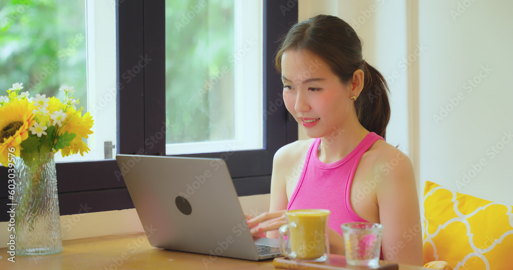 Freelance woman working in a cafe or restaurant alone. She uses the computer to work and search for information in restaurants. Freelance woman working in a cafe or restaurant alone. She uses the computer to work and search for information in restaurants.