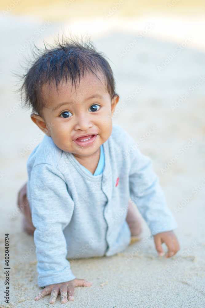 baby boy playing on the sandy summer beach near the sea baby boy playing on the sandy summer beach near the sea