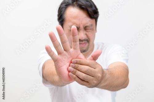 Pain in palm. middle age suffering his palm, man massaging sore zone, health care
