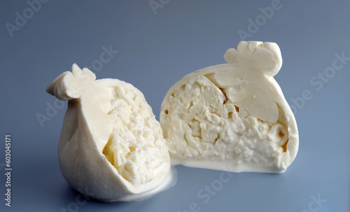 Sliced head of typical Italian cow milk cheese Burrata. Selective focus.