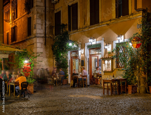 Fototapeta Naklejka Na Ścianę i Meble -  Night cozy old street in Trastevere in Rome, Italy. Trastevere is rione of Rome, on west bank of Tiber in Rome. Architecture and landmark of Rome