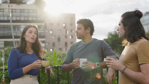 Happy multiracial young people friends talking laughing, diverse students drinking coffee having fun together enjoy multi-ethnic friendship pleasant conversation
