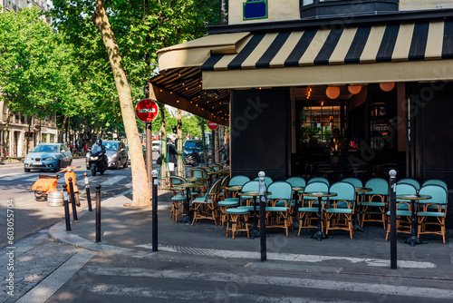 Cozy street with tables of cafe in Paris, France. Cityscape of Paris. Architecture and landmarks of Paris