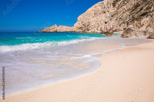  Petani Beach with white sand and azure water against blue sky - Kefalonia island, Ionian sea, Greece.