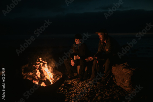 Sitting around the campfire at the beach  photo
