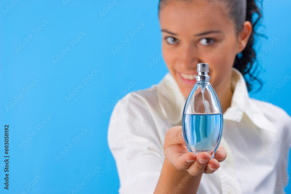 young pretty girl holding perfume young pretty girl holding perfume