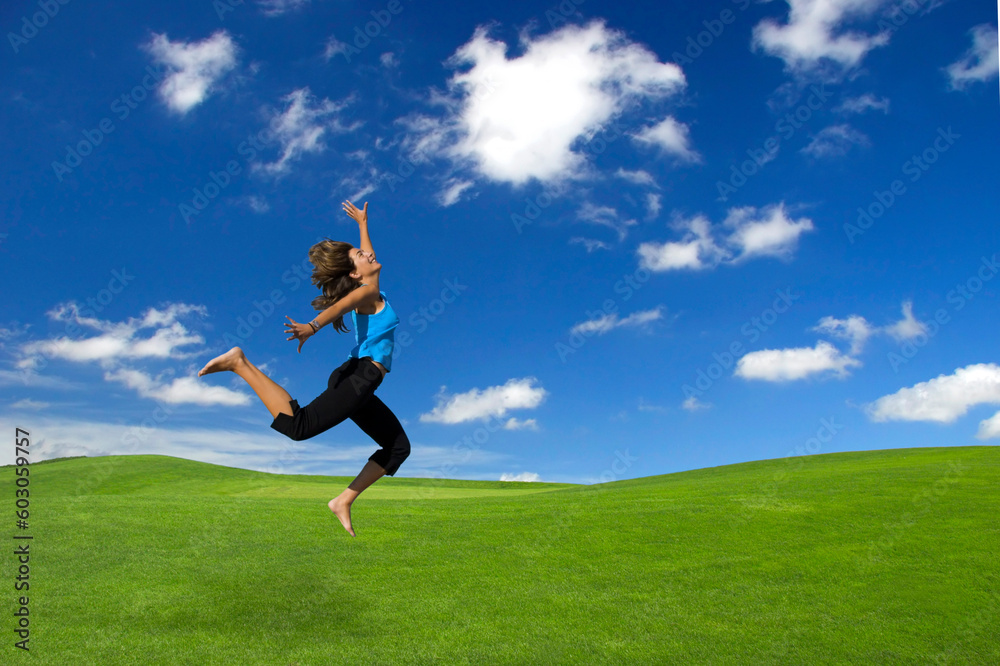 Beautiful athletic woman jumping on a green field Beautiful athletic woman jumping on a green field