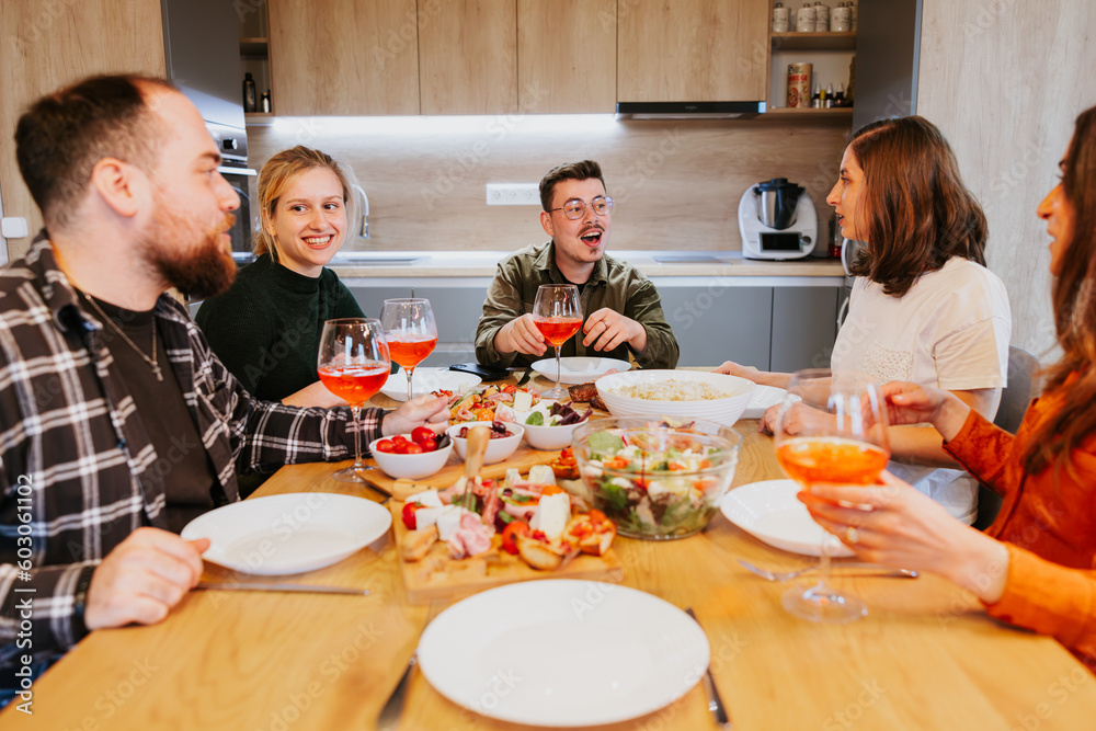 Dinner with friends in a modern home. Smiles and liveliness. Dinner with friends in a modern home. Smiles and liveliness.