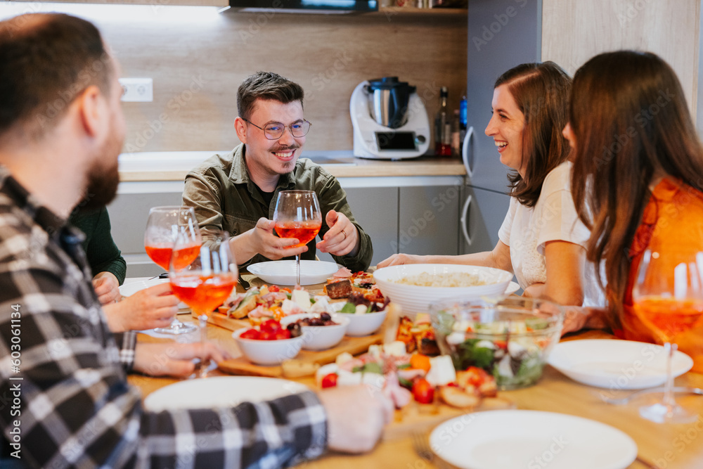 Radiant group of friends gathered around the table enjoying Mediterranean brunch and wine. Radiant group of friends gathered around the table enjoying Mediterranean brunch and wine.