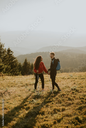 Smiling couple walking with...