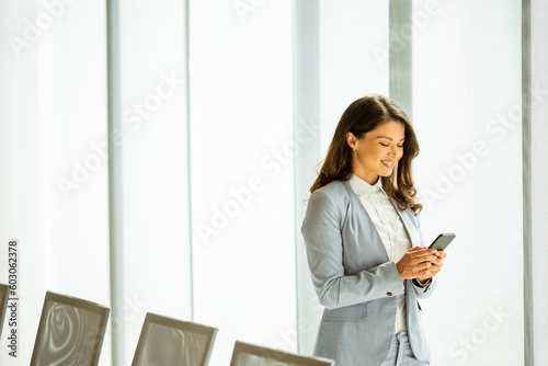 Young woman with mobile pho...