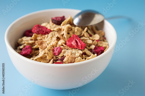 Close up of cereal & fruits on a blue background - shallow dof