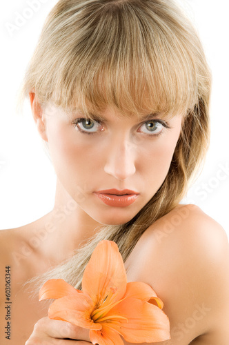 nice blond woman with lomg hair and a flower in orange color in her hand photo