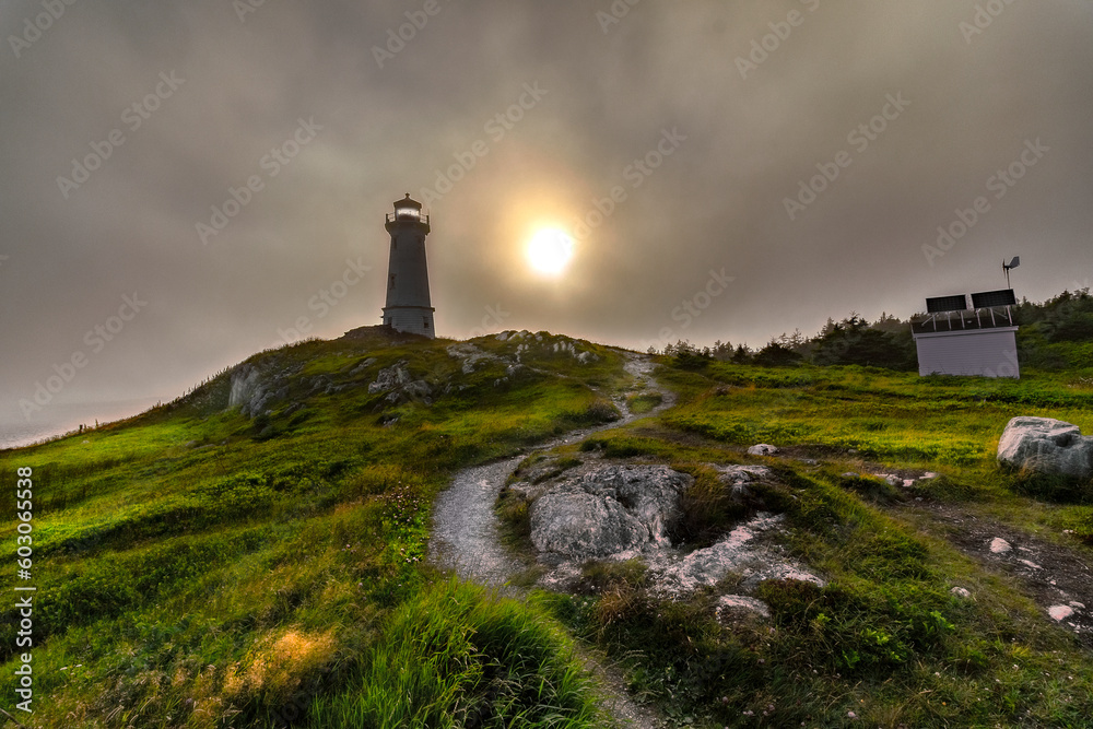 lighthouse on the hill at sunset