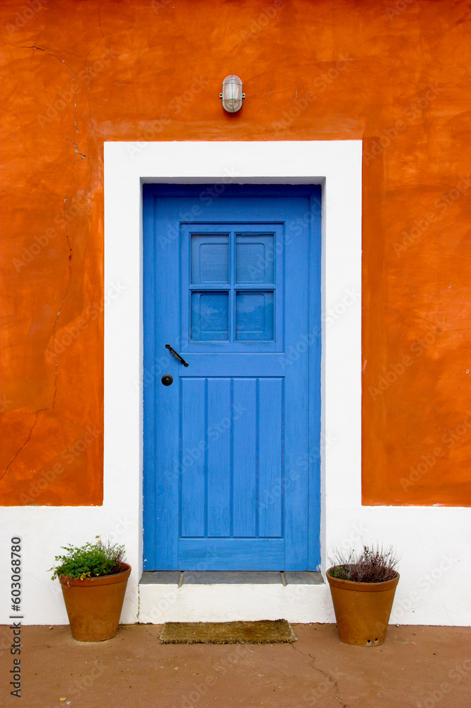 Beautiful and funny orange house with blue doors and windows