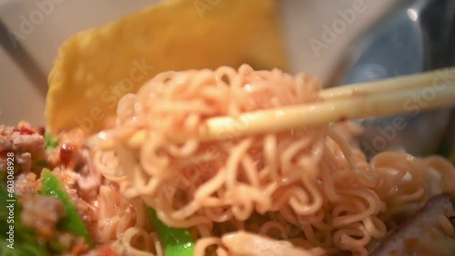 The instant noodles are really delicious, mixed with fish balls and sliced red pork. photo